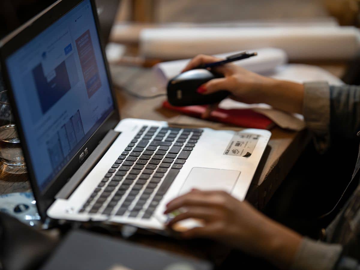 woman working on computer uploading an image to canva